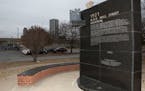 FILE - In this Dec. 15, 2016 file photo, a memorial to Tulsa's Black Wall Street sits outside the Greenwood Cultural Center on the outskirts of downto