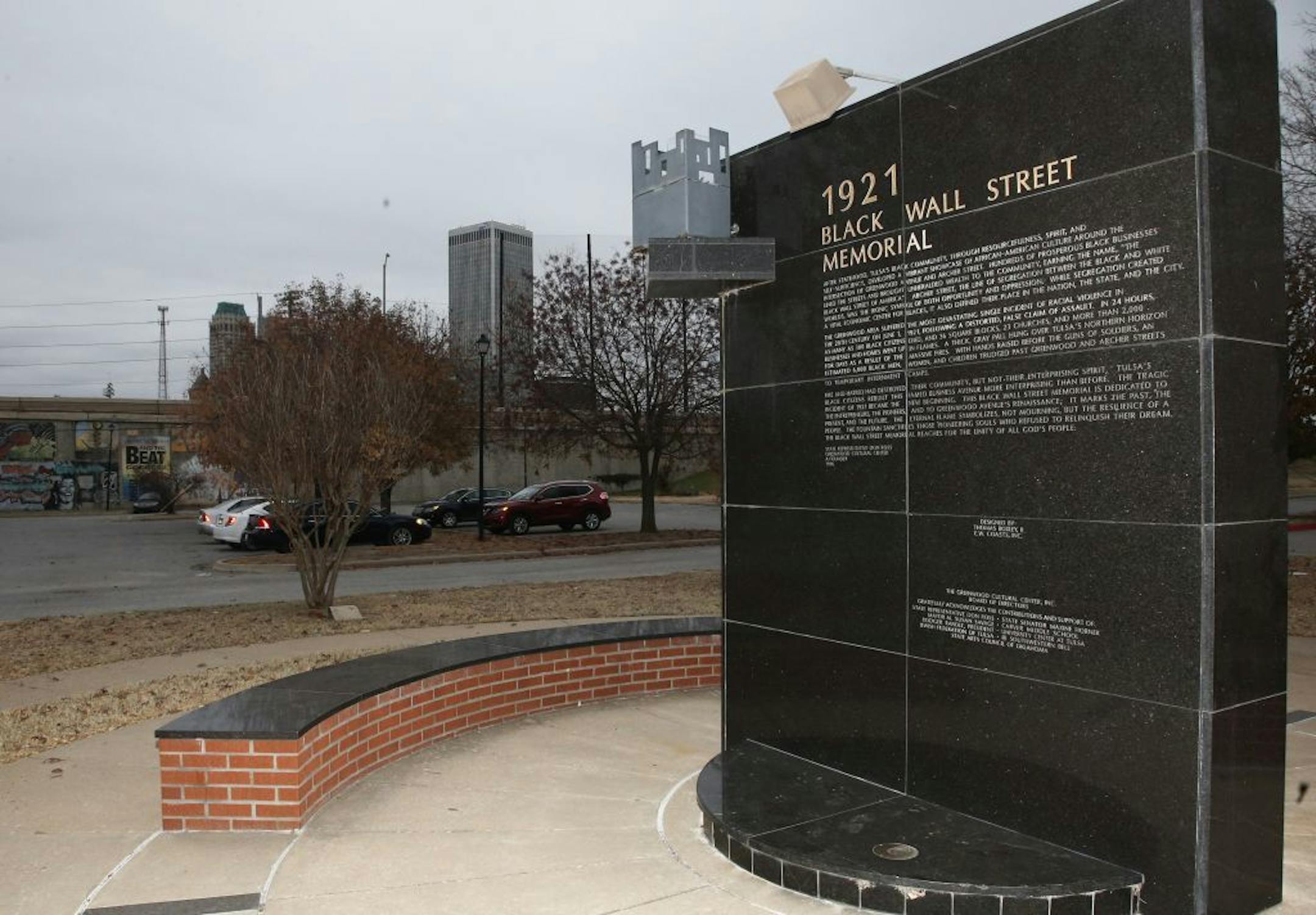 FILE - In this Dec. 15, 2016 file photo, a memorial to Tulsa's Black Wall Street sits outside the Greenwood Cultural Center on the outskirts of downtown Tulsa, Okla. A once-prosperous section of Tulsa that became the site of one of the worst race riots in American history is attempting to remake itself again after decades of neglect. G.T. Bynum mayor of Tulsa said on Tuesday, Oct. 2, 2018, he plans to re-examine whether mass graves hold remains of those killed in one of the nation's worst race m
