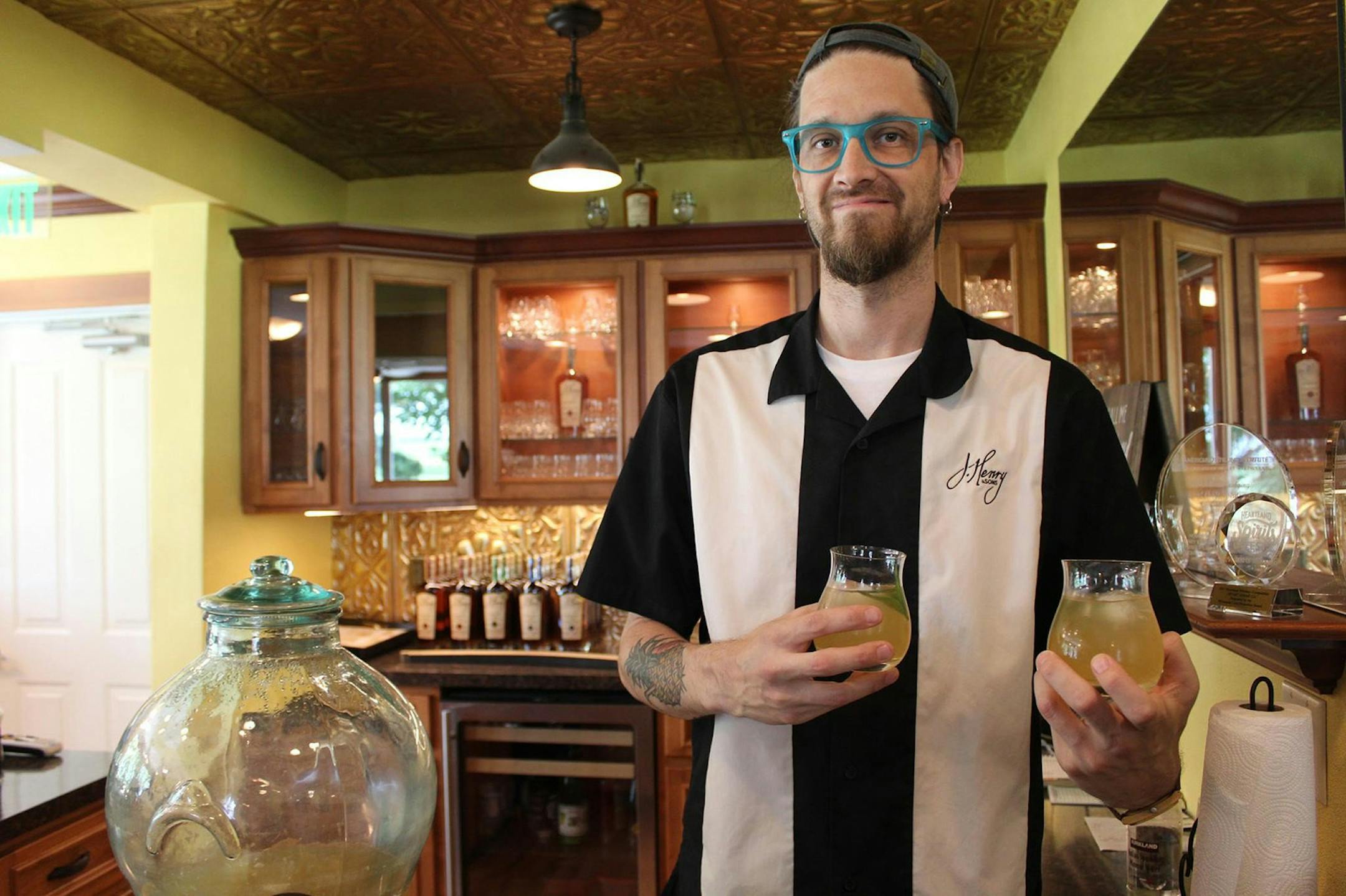 Aaron Rostad gets ready to pass out the Farmer's Cocktail, the welcome drink of the day at J. Henry and Sons, near Madison, Wis.