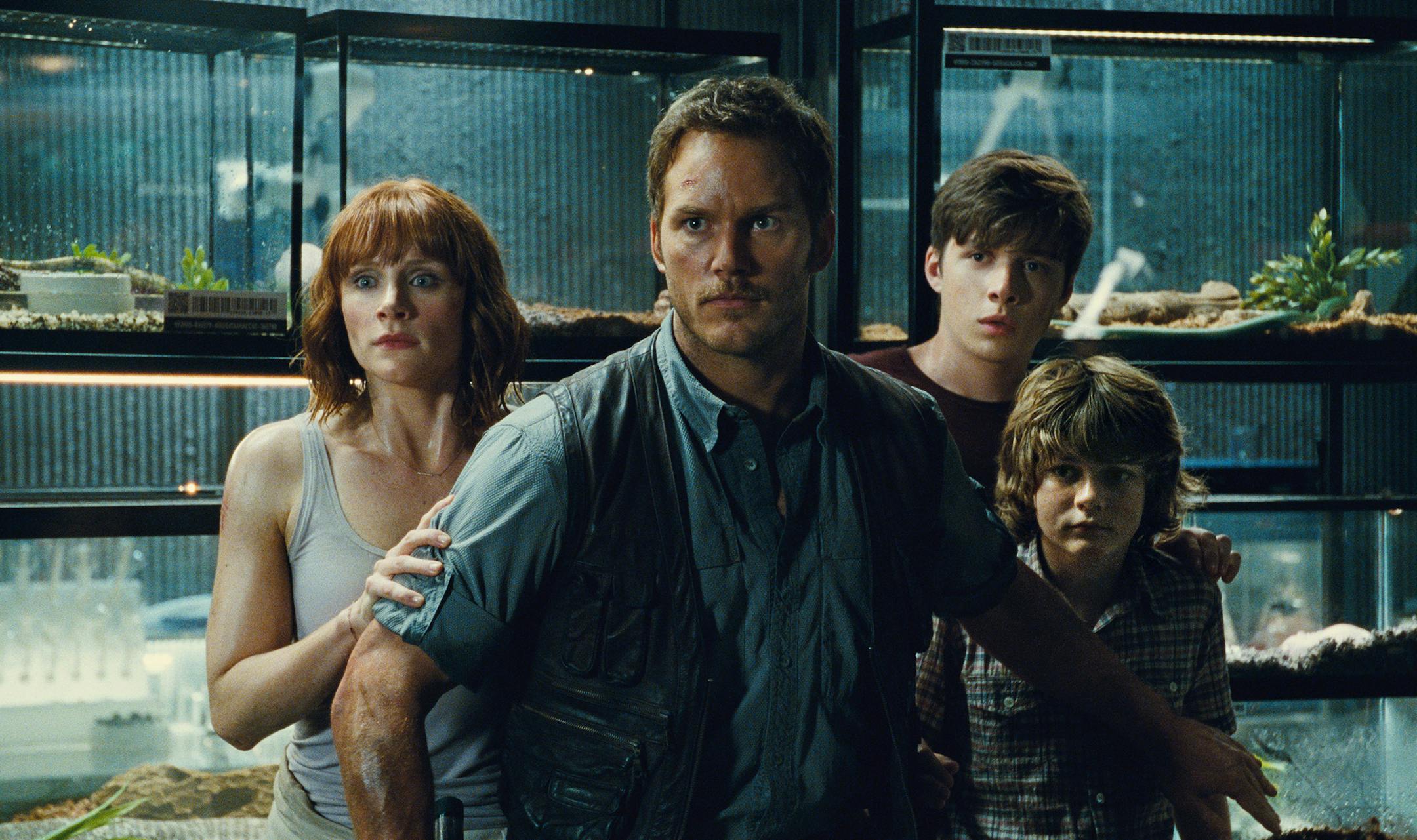 This photo provided by Universal Pictures shows, Bryce Dallas Howard, from left, as Claire, Chris Pratt as Owen, Nick Robinson as Zach, and Ty Simpkins as Gray, in a scene from the film, "Jurassic World."