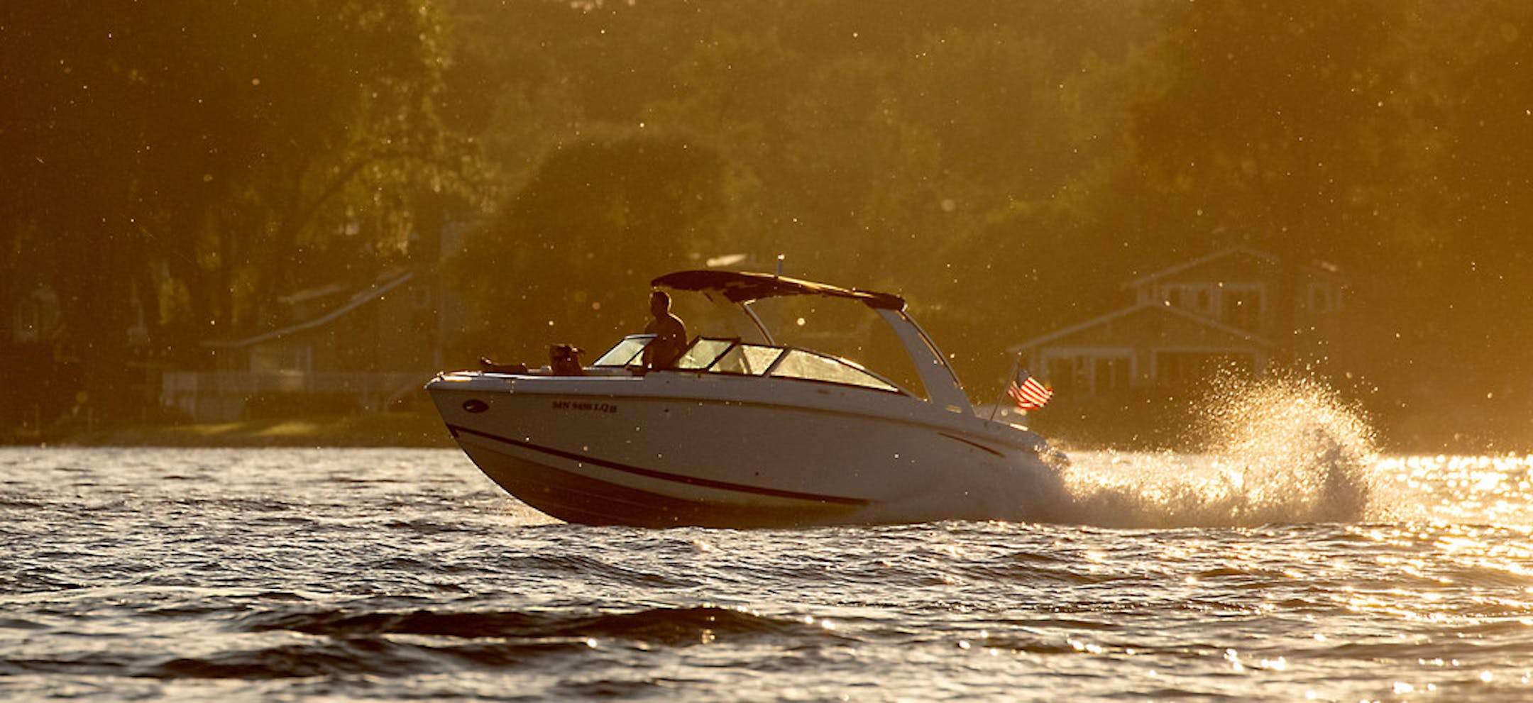 Boaters took to the water as the sun set on Lake Minnetonka on July 2, 2019. Traffic to Big Island was down about one-third over the holiday weekend this year.