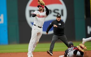 The Twins' Byron Buxton (25) steals second base behind Guardians second baseman Daniel Schneemann in the sixth inning Wednesday night, the 100th stole