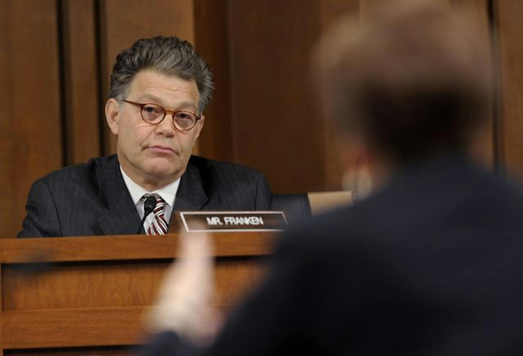 Senate Judiciary Committee member Sen. Al Franken, D-Minn., left, listens to Supreme Court nominee Elena Kagan, right, as she testifies on Capitol Hill in Washington, Wednesday, June 30, 2010