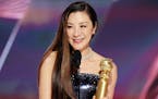 This image released by NBC shows Michelle Yeoh accepting the Best Actress in a Motion Picture – Musical or Comedy award for "Everything Everywhere A