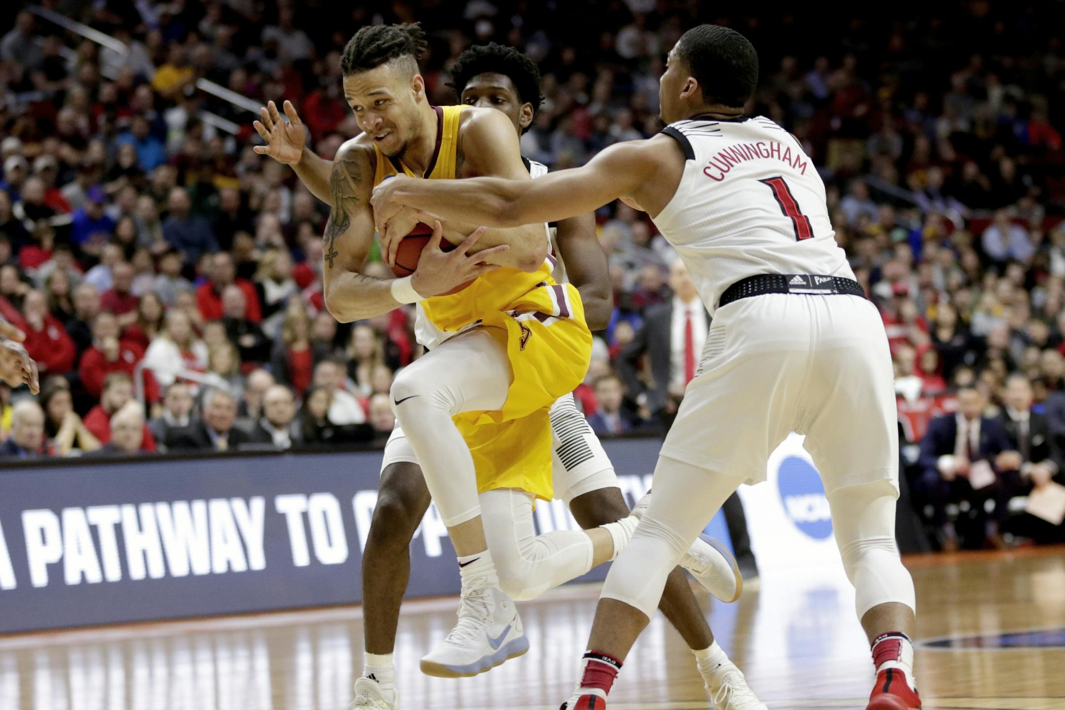 Minnesota's Amir Coffey (5) drives to the basket past Louisville's Christen Cunningham (1) during the second half of a first round men's college basketball game in the NCAA Tournament, in Des Moines, Iowa, Thursday, March 21, 2019.