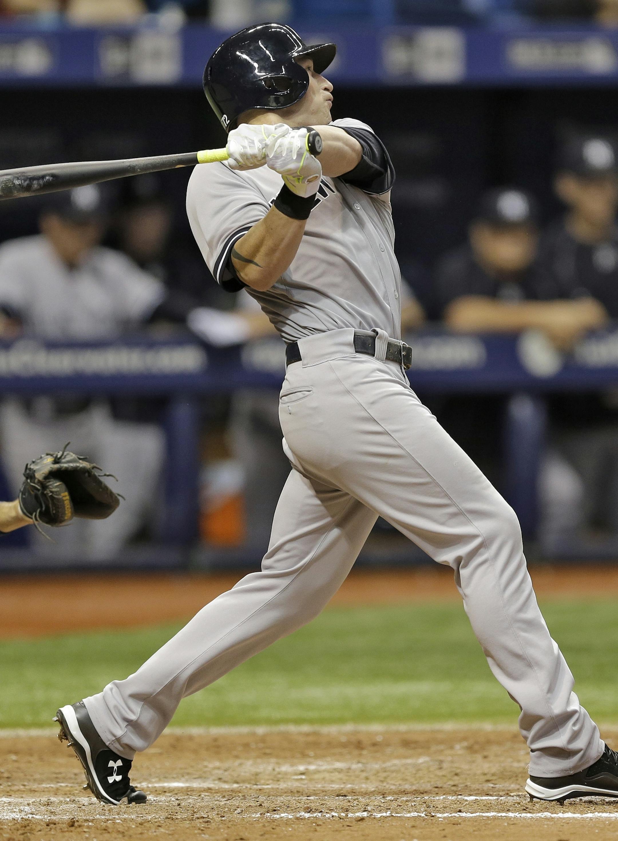 New York Yankees' Slade Heathcott follows the flight of his three-run home run off Tampa Bay Rays relief pitcher Brad Boxberger during the ninth inning of a baseball game Monday, Sept. 14, 2015, in St. Petersburg, Fla. Catching for the Rays is J.P. Arencibia. (AP Photo/Chris O'Meara)