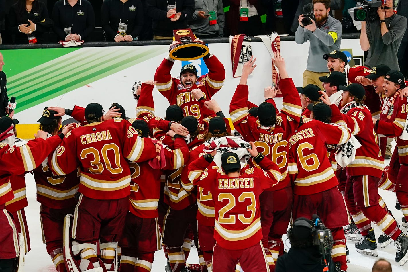 Denver captain Cole Guttman (19) lifts the championship trophy after beating Minnesota State in the NCAA Division I National Championship game Saturday, April 9, 2022 in Boston, Mass. Photo by Mansoor Ahmad/The Reporter.