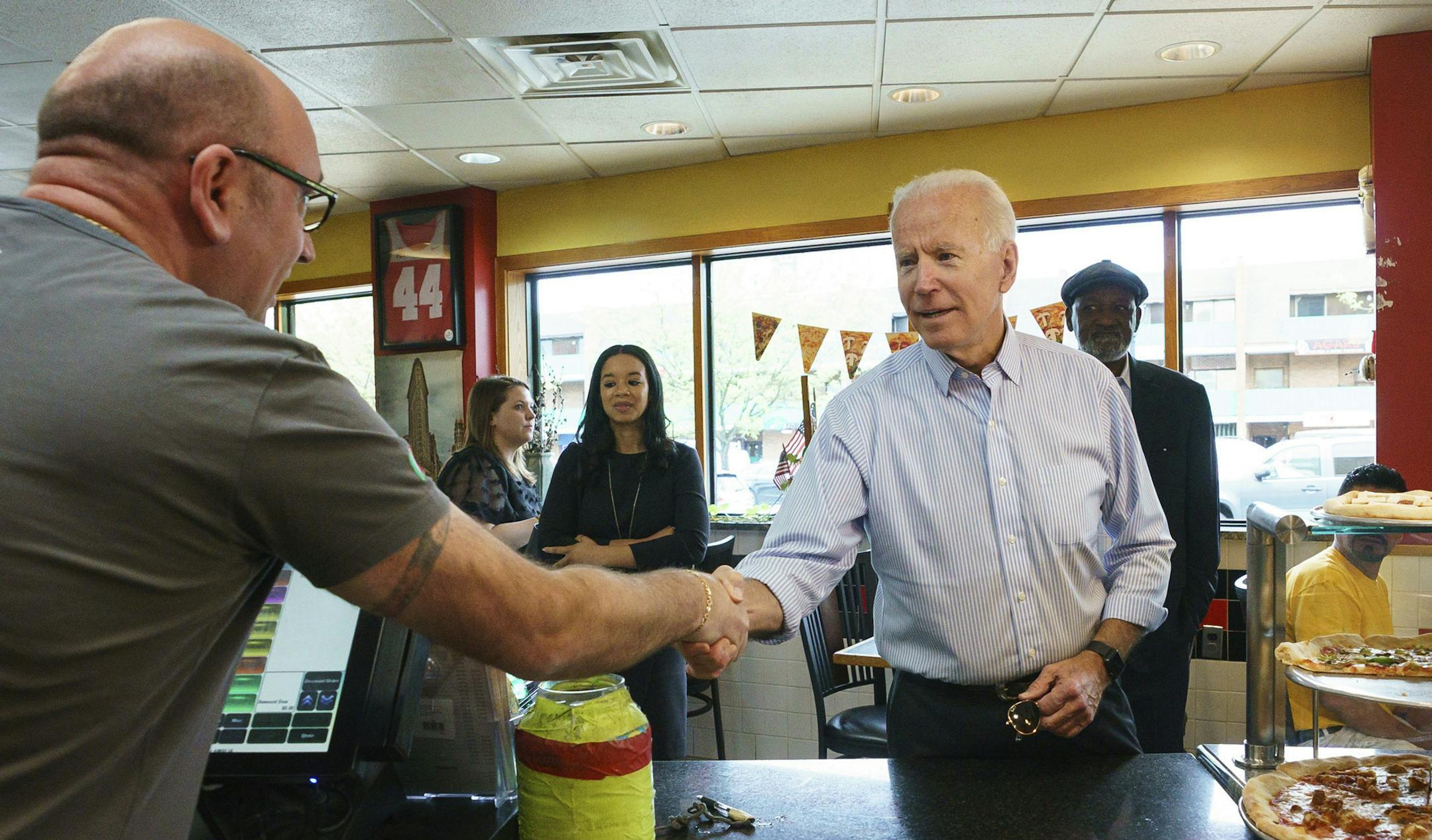 Democratic presidential candidate and former Vice President Joe Biden greets people at Gianni's Pizza, in Wilmington Del., Thursday, April 25, 2019. Jessica Griffin/The Philadelphia Inquirer via AP)