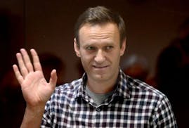 Russian opposition leader Alexei Navalny stands inside a glass cell during a court hearing at the Babushkinsky district court in Moscow on Feb. 20, 20