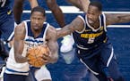 Ed Davis (of the Timberwolves fought for a ball with Will Barton of the Nuggets in the first quarter.