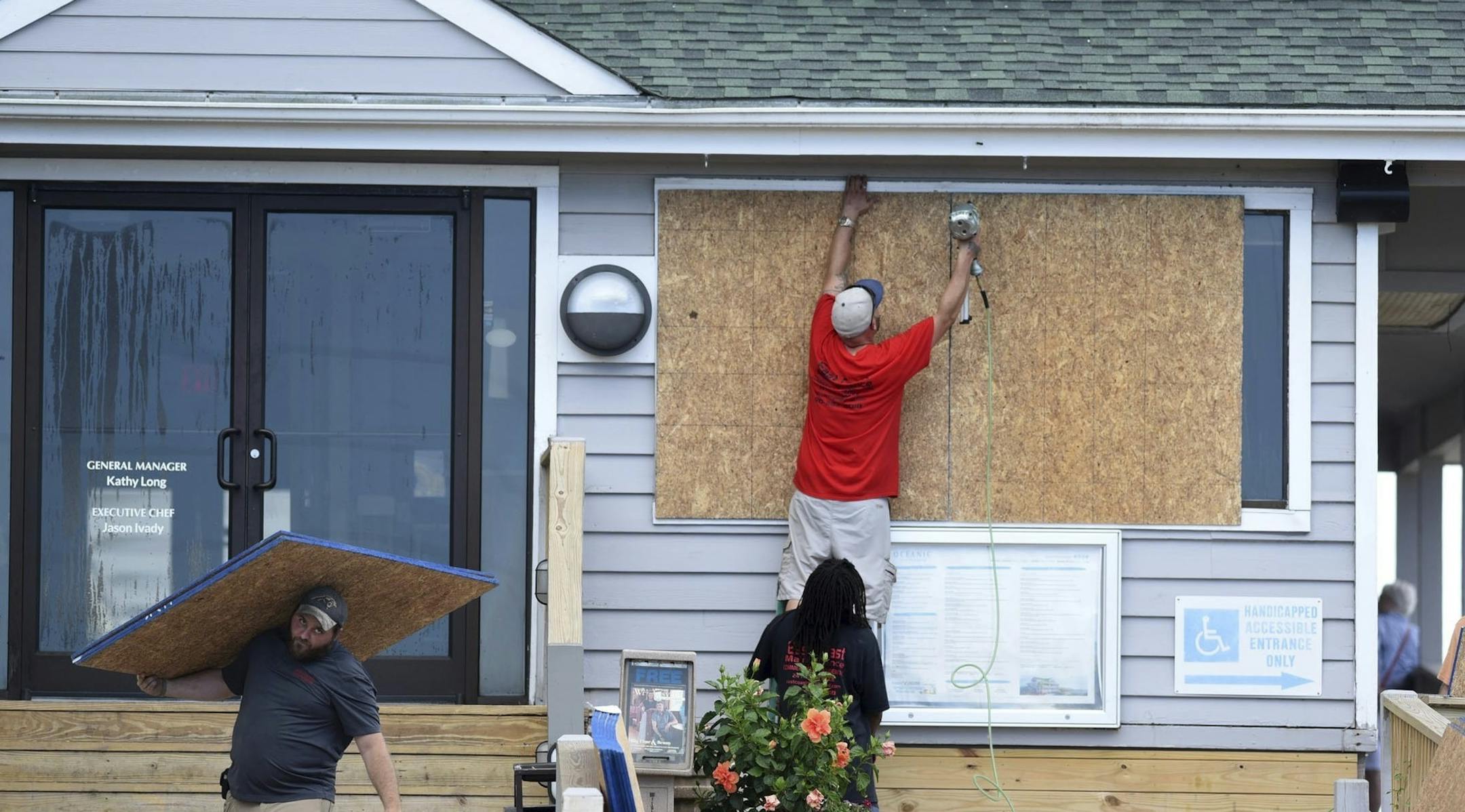 Crews board up the Oceanic restaurant in Wrightsville Beach, N.C., Tuesday, Sept. 11, 2018, in preparation for Hurricane Florence. (Matt Born/The Star-News via AP)