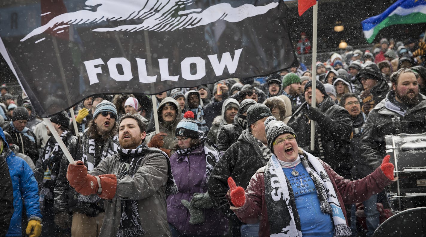 Dark Clouds member Doreen Hartzell (bottom right) joined fellow supper fans in the supporters section behind the goal for the home opener of the inaugural season on March 12th. The snow and cold couldn&#xd5;t keep 35,043 fans from showing up to support Minnesota United for their MLS home opener against fellow expansion side Atlanta United. The packed house at TCF Bank Stadium was the largest crowd for a soccer match in Minnesota since the Strikers defeated the Tampa Bay Rowdies in front of 52,62