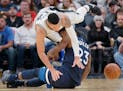 San Antonio Spurs' Danny Green collides with Minnesota Timberwolves' Jimmy Butler (23) during the second half of an NBA basketball game, Wednesday, Oc