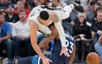 San Antonio Spurs' Danny Green collides with Minnesota Timberwolves' Jimmy Butler (23) during the second half of an NBA basketball game, Wednesday, Oc