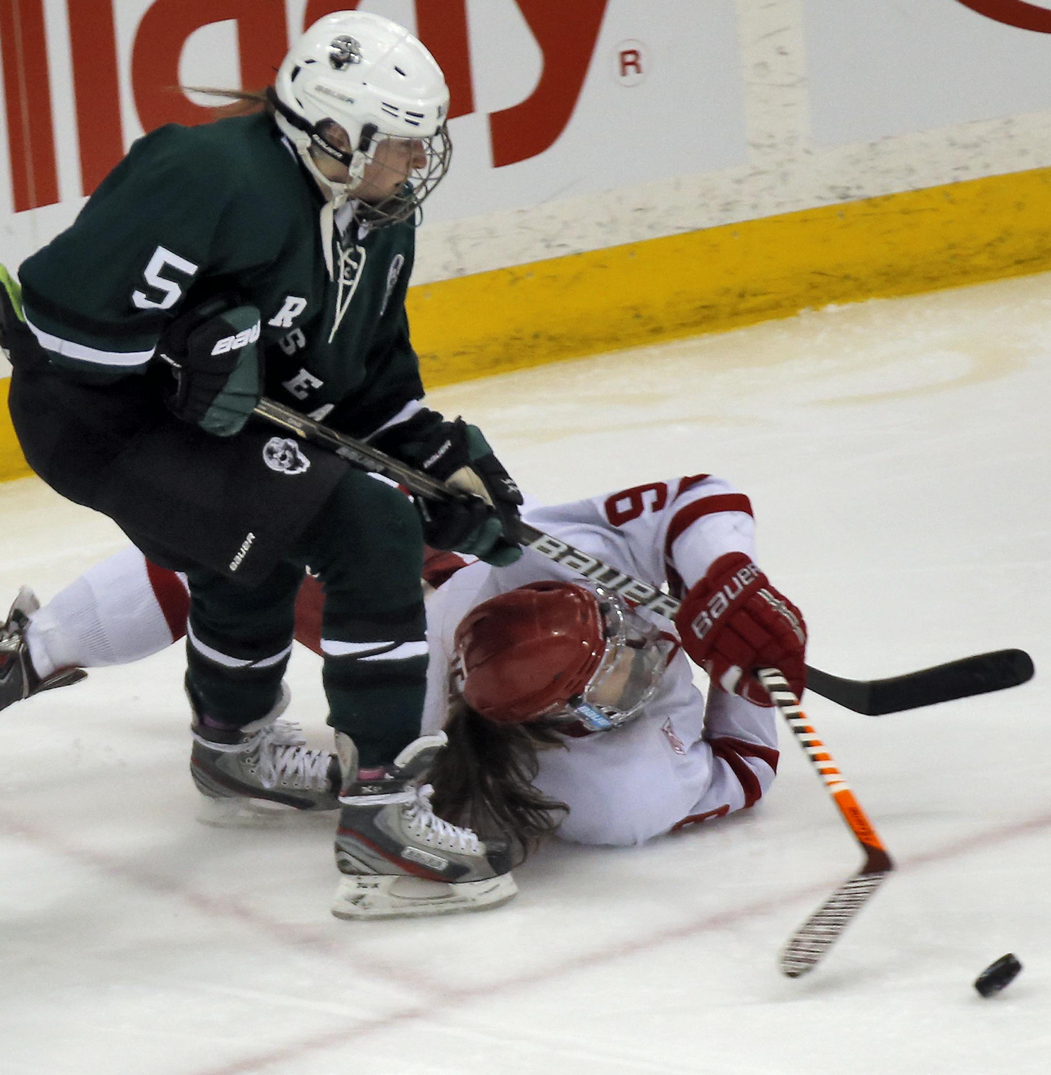 Girls State Hockey Tournament - Class 2A - Roseau Rams vs. Benilde-St. Margaret's Red Knights. Rams Madeline Huglen (5) and Red Knights Caitlin Reilly (9) fought for control of the puck. (MARLIN LEVISON/STARTRIBUNE(mlevison@startribune.com)
