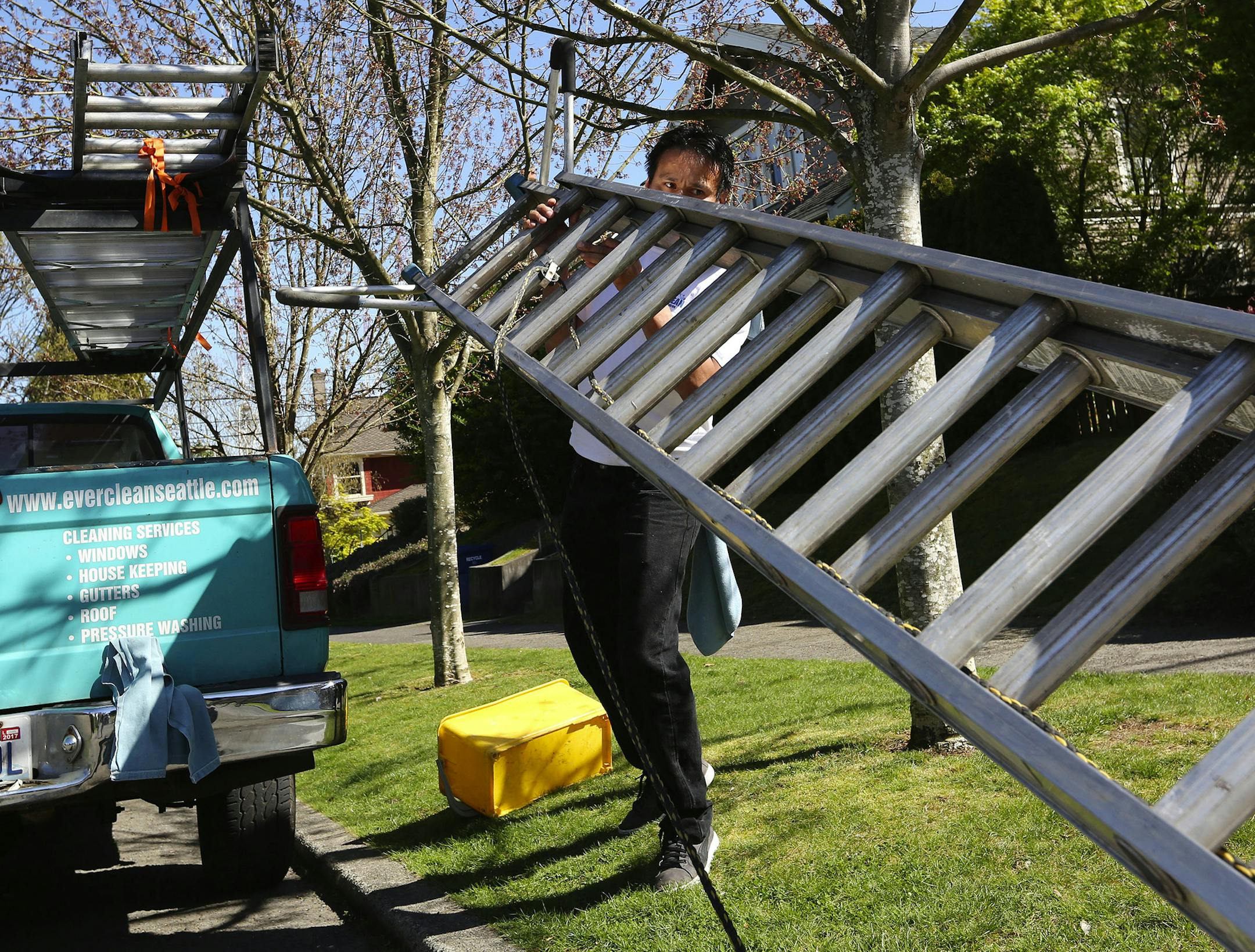 Juan Marin, owner of Everclean Cleaning Service, prepares to wash windows for a client. His business has improved since signing up with Amazon Home Services, a marketplace for local cleaners, electricians, etc. (Ken Lambert/Seattle Times/TNS) ORG XMIT: 1183630
