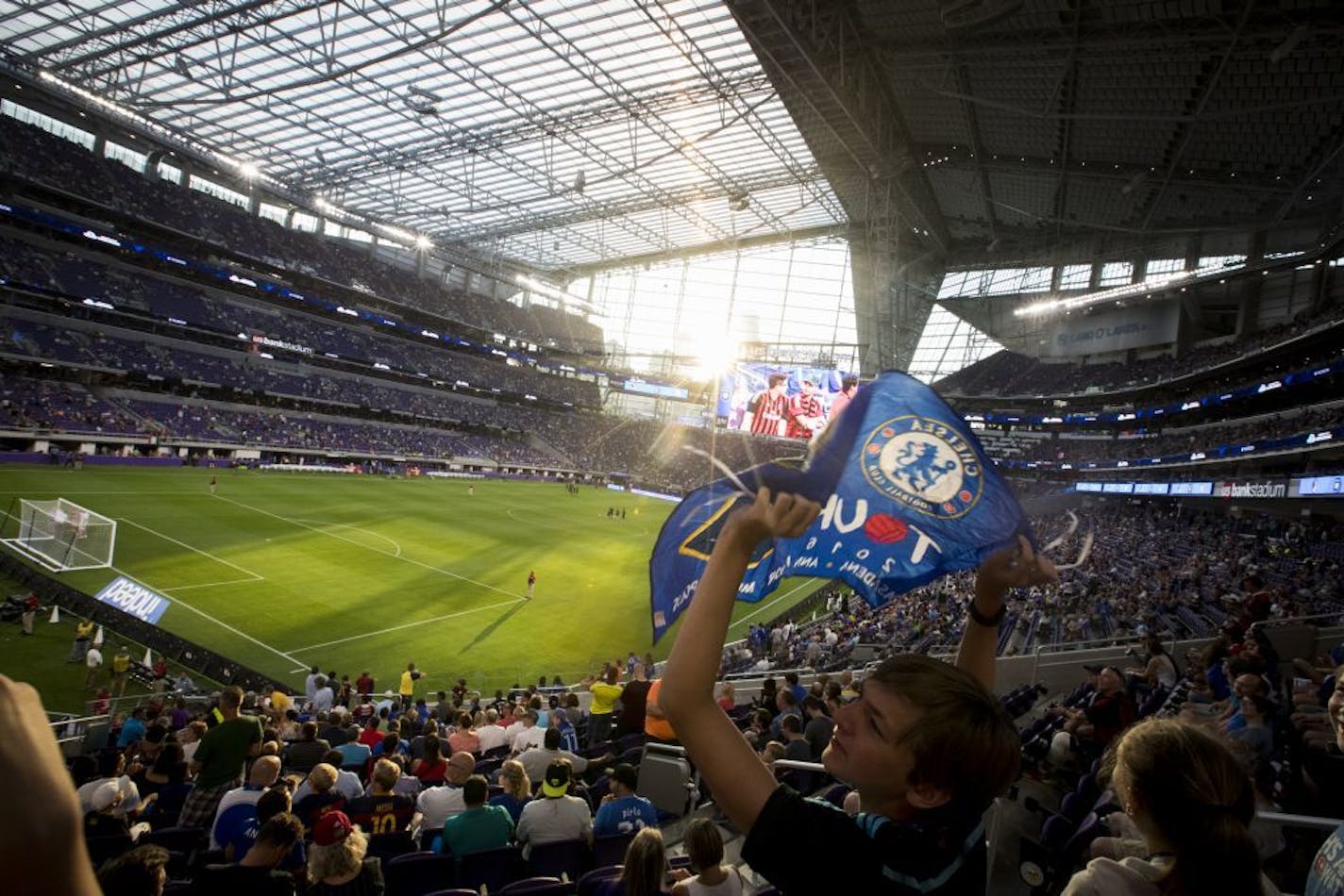 Andrew Sime, 13, waved a Chelsea flag as he sat in his seat with a full crowd at U.S. Bank Stadium for the Chelsea F.C. verses A.C. Milan match on Wednesday, August 3, 2016, in Minneapolis, Minn.