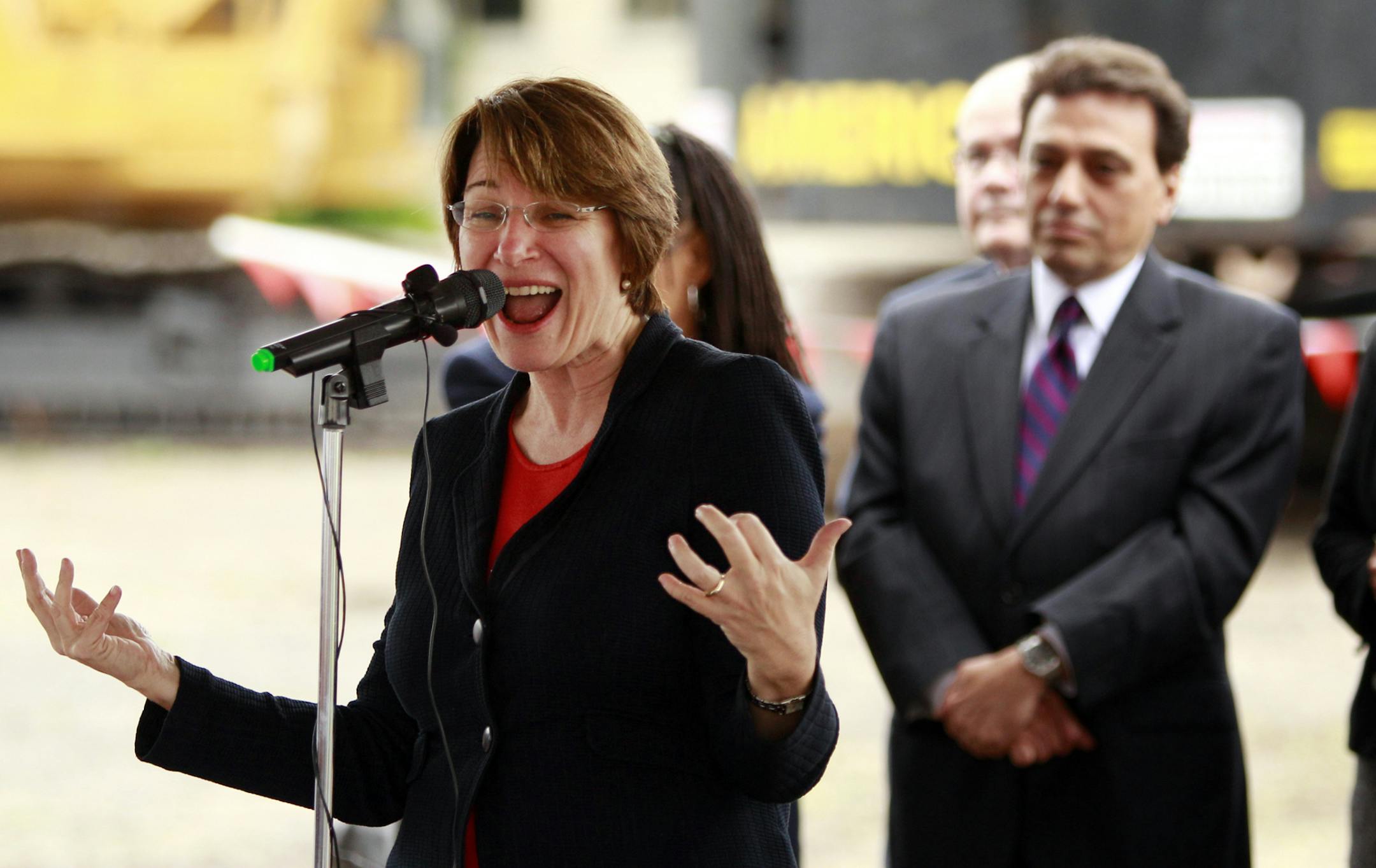 Sen. Amy Klobuchar speaks as Ramsey County Commissioner Rafael Ortega, back left, and Congresswoman Betty McCollum, back right, listen during a ceremony celebrating the continued demolition of the former Twin Cities Army Ammunition Plant (TCAAP) in Arden Hills, Friday, June 7, 2013. (Genevieve Ross/Special to the Star Tribune) ORG XMIT: 05TCAAP060813