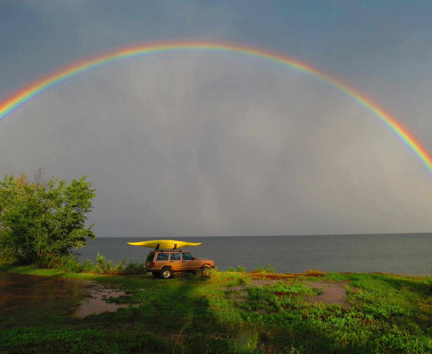 ? Dale K. Mize, Plymouth, MN
Where were you when you took this photo? What does it show? It was the afternoon driving back from a visit to Split Rock State Park. I pulled in to Flood Bay to get a better view of the rainbow I saw from HY61. As I got out of the car, I noticed splotches of sun, particularly how some were hitting the kayak making the yellow really stand out, as well as the sight of the full rainbow. Normally, having a fairly plain auto in a shot would have caused the shot to be rath