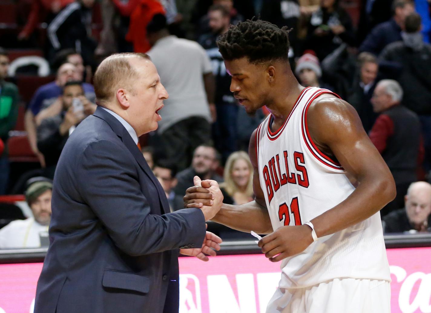 Minnesota Timberwolves head coach Tom Thibodeau, left, shakes hands with his former player Chicago Bulls' Jimmy Butler after an NBA basketball game Tuesday, Dec. 13, 2016, in Chicago. The Timberwolves won 99-94. (AP Photo/Charles Rex Arbogast)