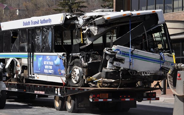 A bus involved in a fatal crash in Duluth early Tuesday is towed away.