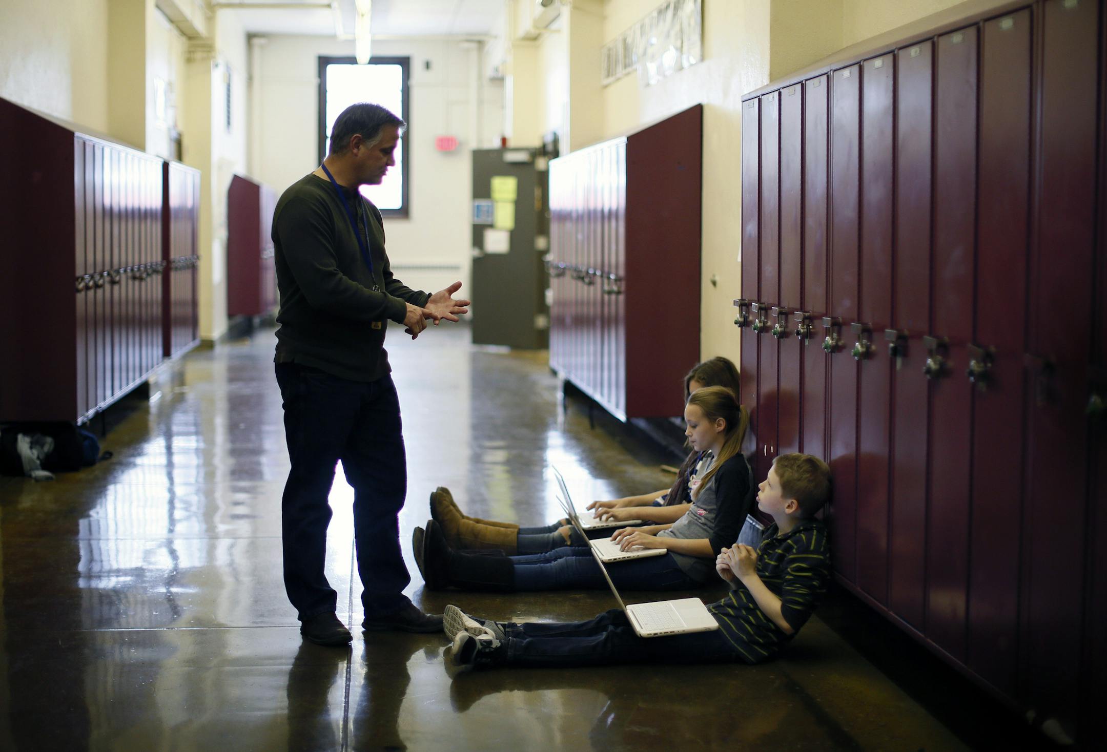 History teacher Eric Sparks works with 7th grade students, Lilah Schulz, Lydia Larson and Walker Ferguson in the hallway at Sanford Middle School. Sparks has a flexible classroom, allowing some students to work in the hallway during class. ] Fifteen years ago, when Meredith Davis arrived at Sanford Middle School in Minneapolis, her mother's alma mater attracted hardly any of its neighborhood's kids. It had the second-worst scores on one state test of any school in Minnesota. To keep the school g