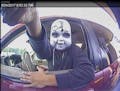 A suspect believed to have placed skimmers at outdoor ATM machines dons a skull-type mask to conceal his identity