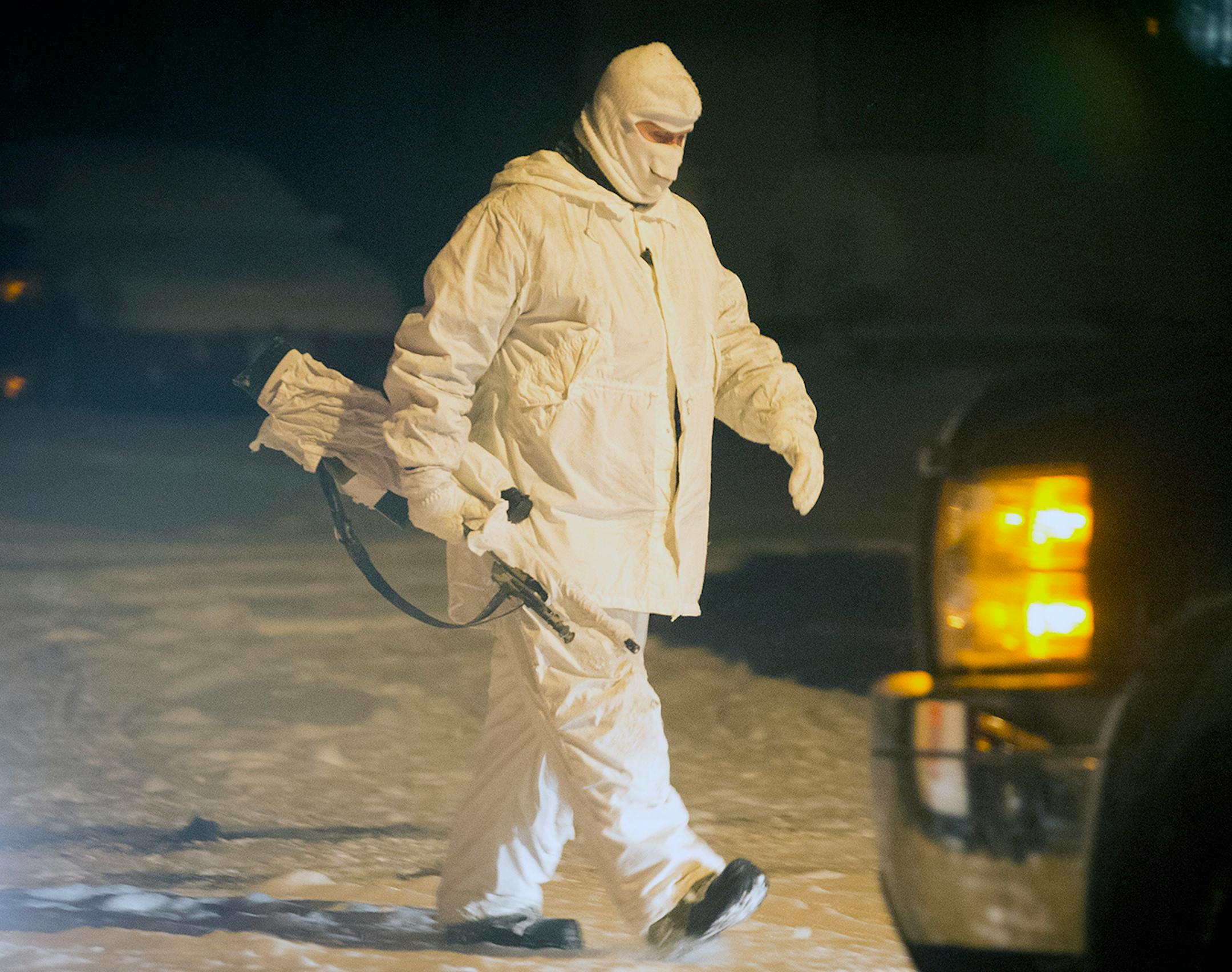 A police sniper leaves their position during a standoff Tuesday night in Jordan.