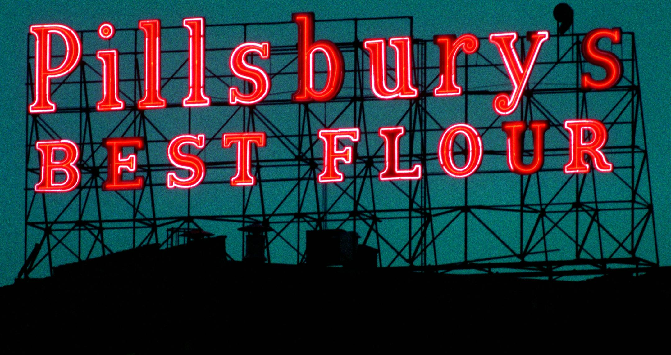 Minneapolis Preservation Commission hearing on Pillsbury sign -- The Pillsbury Best flour sign lit up at night. The sign is located in the Riverfront neighborhood near Main Street across from St. Anthony Falls.