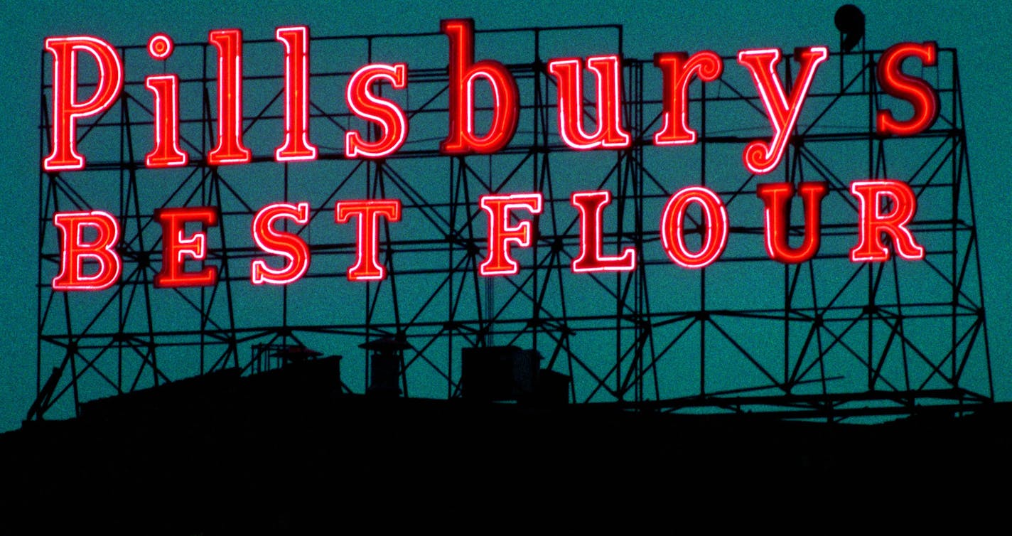 Minneapolis Preservation Commission hearing on Pillsbury sign -- The Pillsbury Best flour sign lit up at night. The sign is located in the Riverfront neighborhood near Main Street across from St. Anthony Falls.