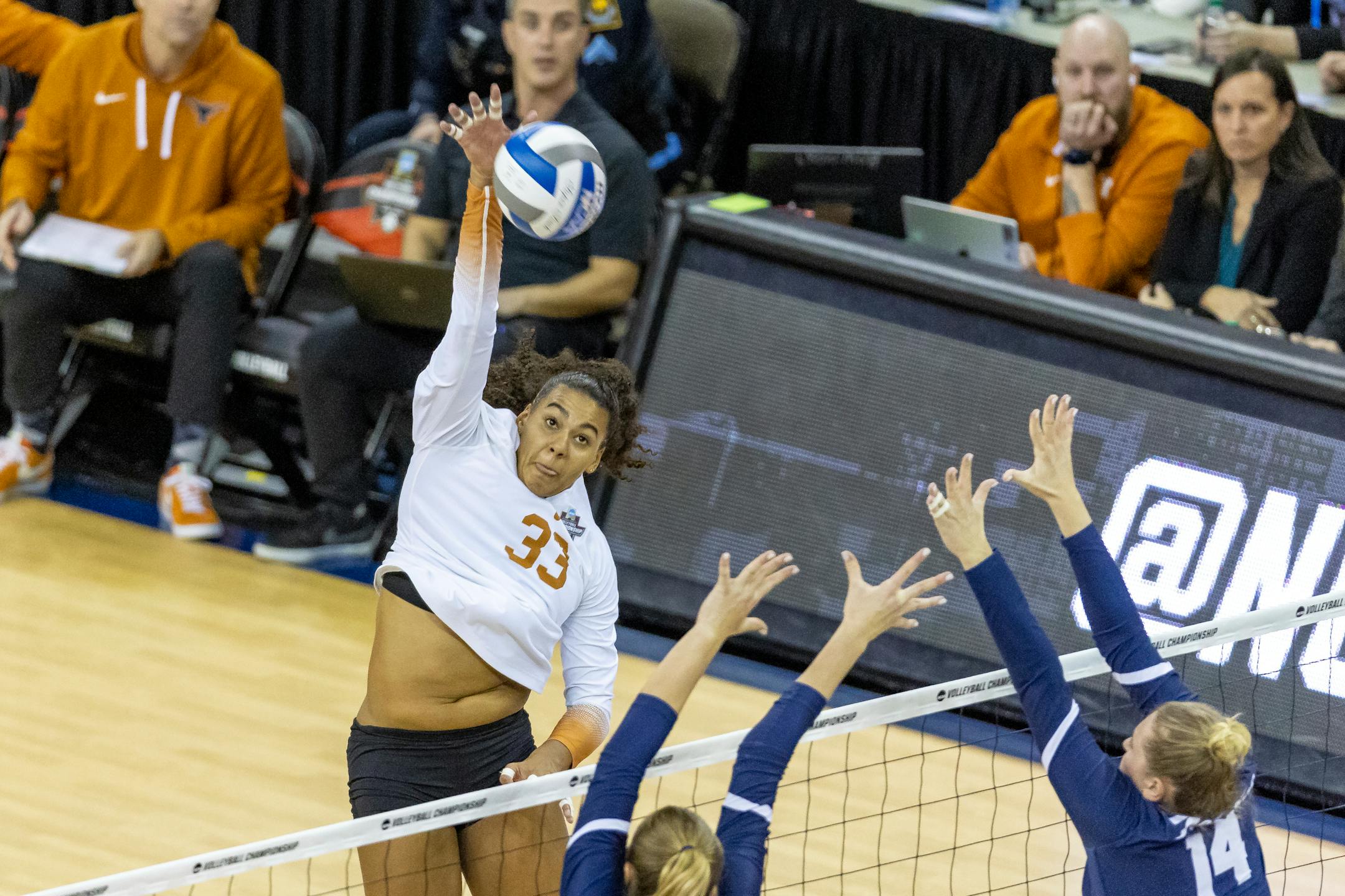 Texas Logan Eggleston (33) spikes the ball against San Diego Leyla Blackwell (7) and Breana Edwards (14) in the first set during the semifinals of the NCAA volleyball tournament, Thursday, Dec. 15, 2022 in Omaha, Neb. (AP Photo/John S. Peterson)