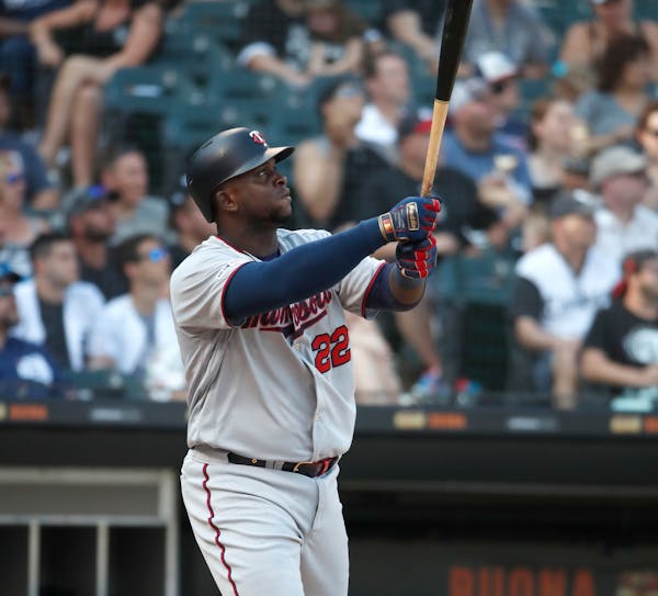 Miguel Sano watches his two-run home run during the eighth inning