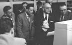 Irma Wyman demonstrates the Datamatic 1000 to officials from the U.S. Treasury's punched card U. S. Savings Bond division.