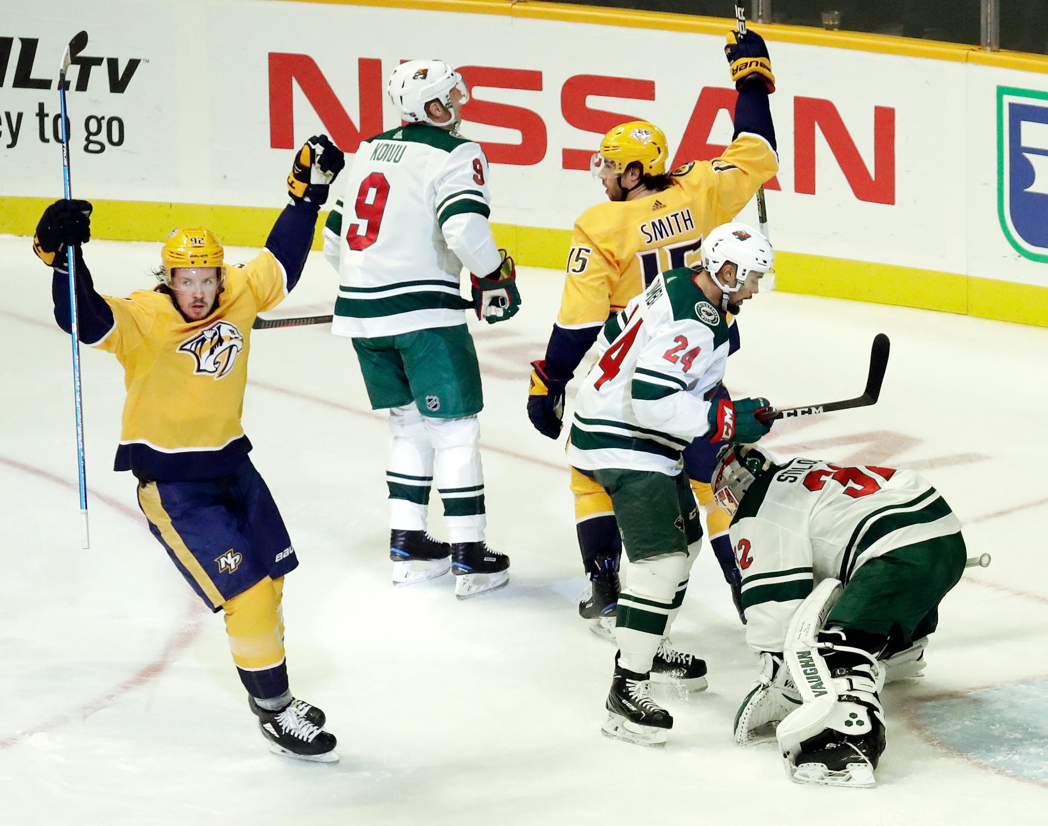 Predators right winger Craig Smith (15) and Ryan Johansen, left, celebrated after Smith scored a goal against Wild goaltender Alex Stalock in the first period Monday.