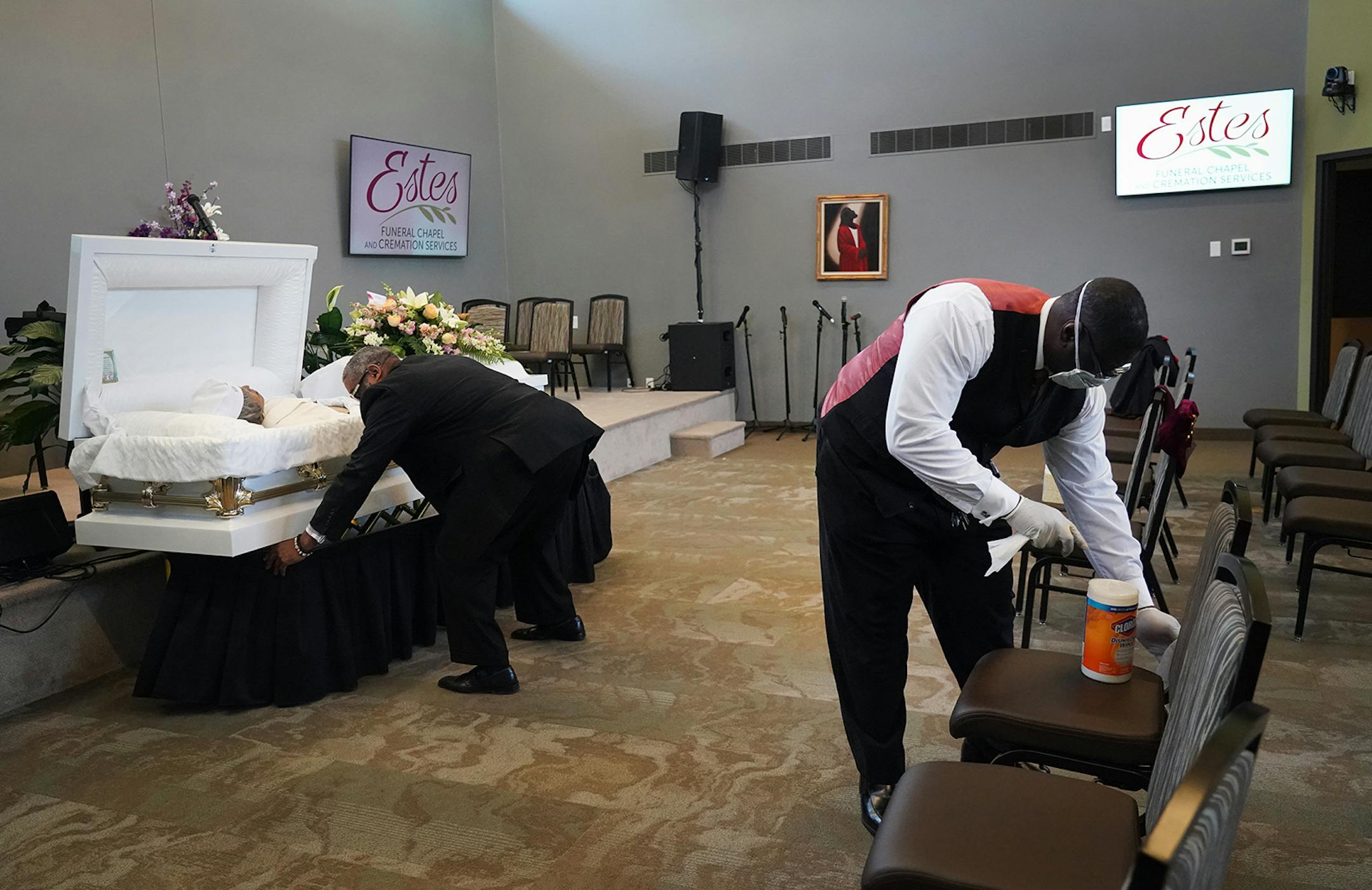 Estes Funeral Chapel's Tracy Wesley, Sr. (left) and Curtis Mayfield disinfected a chapel between services. Estes Funeral Home in Minneapolis is taking extra precautions during the COVID-19 breakout, including extra cleaning between memorial services. Since 2018, Estes has been wired to provide livestreaming video which they encourage people to use to stay safe away from crowds and still feel part of their loved one's service.