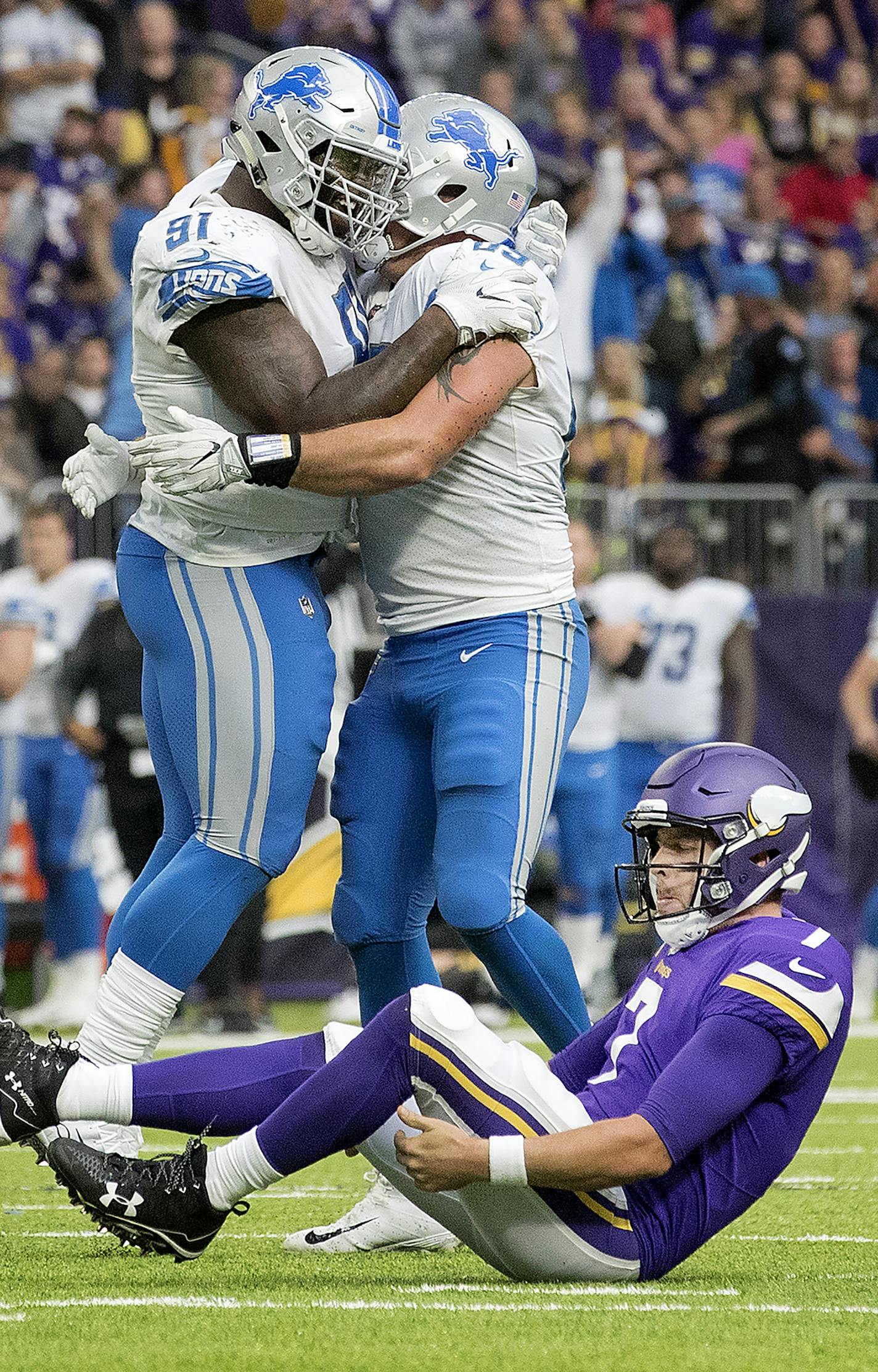 Minnesota Vikings Case Keenum (7) got up after being sacked by Anthony Zettel (69) in the fourth quarter. Lions A&#xed;Shawn Robinson and Anthony Zettel (69) celebrated in the background. ] CARLOS GONZALEZ &#xef; cgonzalez@startribune.com - October 1, 2017, Minneapolis, MN, NFL, US Bank Stadium, Minnesota Vikings vs. Detroit Tigers