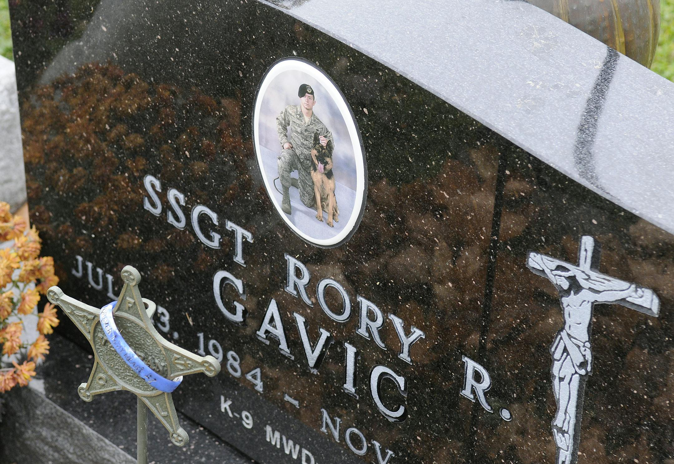 In this Nov. 7, 2014 photo, the grave of Rory Gavic is displayed at St. Francis Catholic Cemetery near Buffalo, Minn. Gavic was a young, decorated military member who served his country overseas twice, who had earned praise and the respect of his peers, who had volunteered as a Big Brother. His suicide in 2009 devastated his family, especially his mother Linda Sawatzke who killed herself four years later with the same handgun. (AP Photo/The St. Cloud Times, Dave Schwarz)