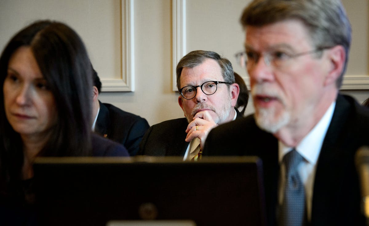 U of M President Eric Kaler, center, listened as Elizabeth Stawicki and State Auditor James Nobles delivered their report related to the death of Dan 