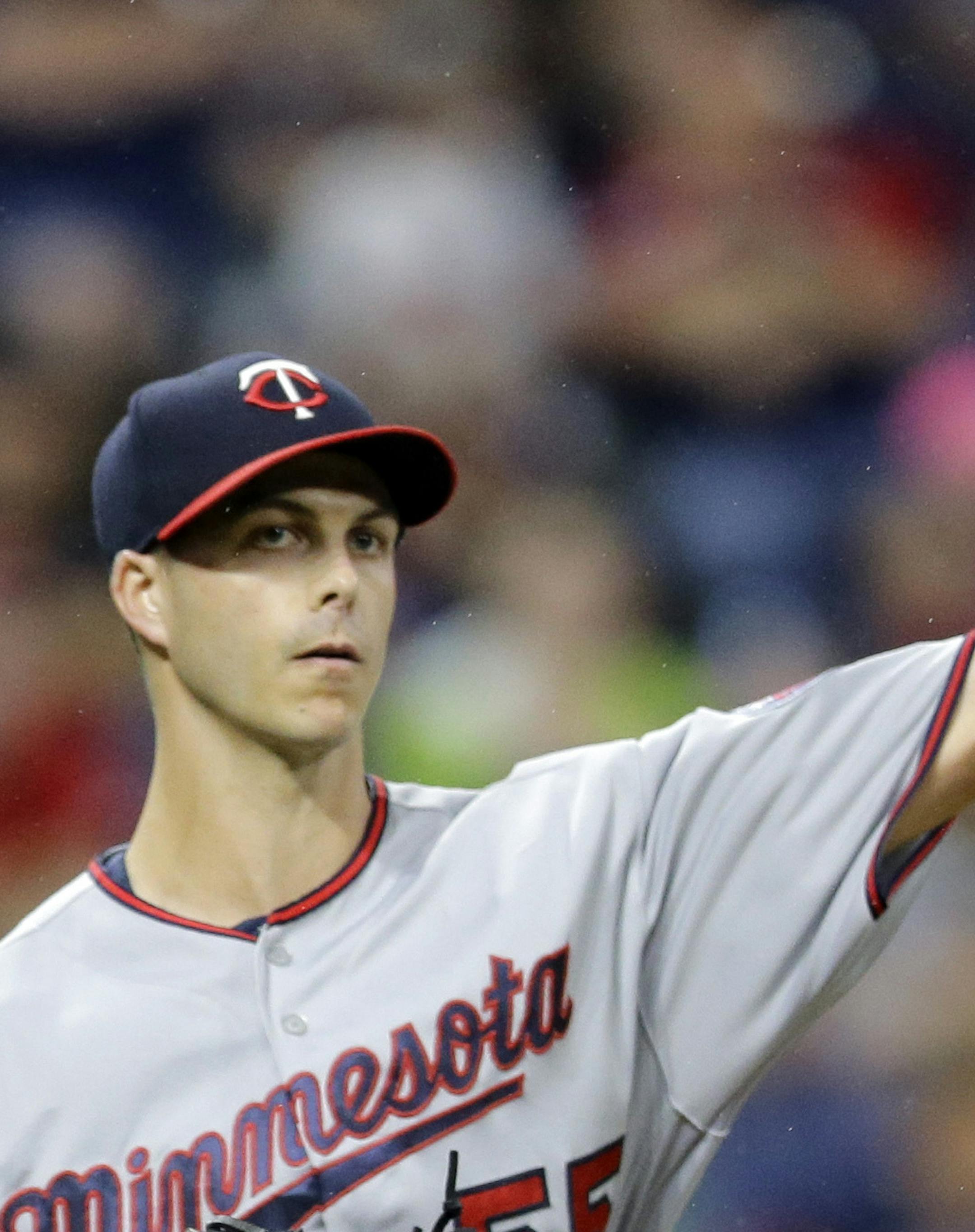 Minnesota Twins relief pitcher Taylor Rogers throws out Cleveland Indians' Lonnie Chisenhall at first base in the eighth inning of a baseball game, Friday, June 23, 2017, in Cleveland. (AP Photo/Tony Dejak)
