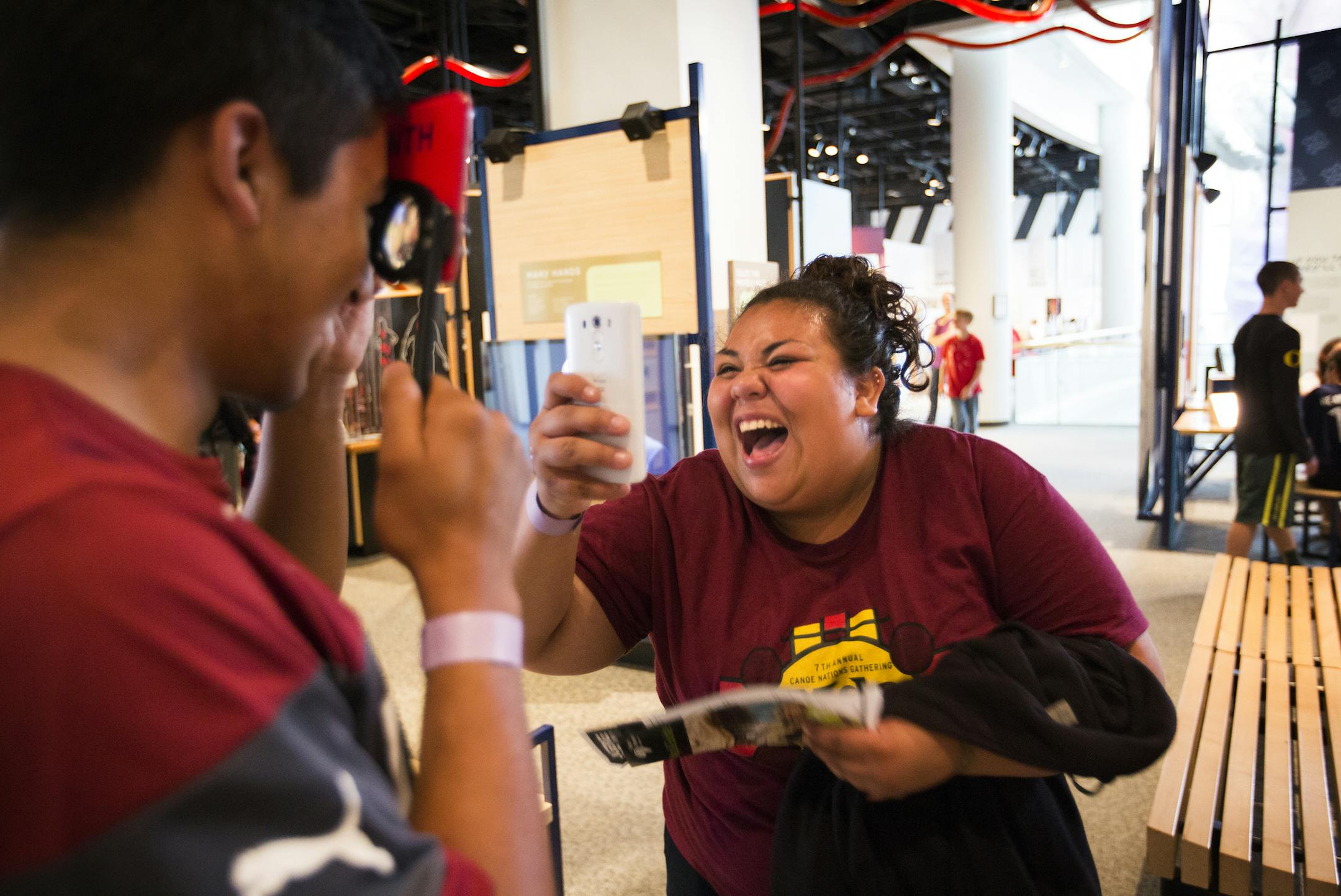 Anastasia Pinney-Valtierra, 18, of Minneapolis, takes photos of classmate Arlindo Hernandez, 17, with glasses on that simulate the sight of a one-month-old baby at the Science Museum of Minnesota in St. Paul on Tuesday, June 30, 2015. ] LEILA NAVIDI leila.navidi@startribune.com / BACKGROUND INFORMATION: As part of &#xec;STEM Day&#xee; at the Science Museum of Minnesota, Native American students from Minneapolis and St. Paul had an opportunity to participate in interactive, hands-on, activities a
