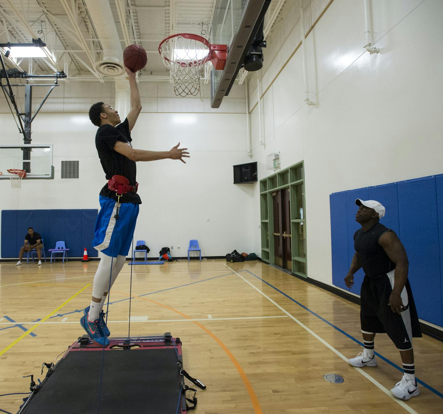 Trainer Tony Wilson, right, pushed Amir Coffey through drills on a jump training resistance board at Grace Church in Eden Prairie.