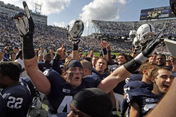Penn State linebacker Michael Mauti, center, celebrates with teammates after the beat Northwestern 39-28 on Oct. 6, 2012