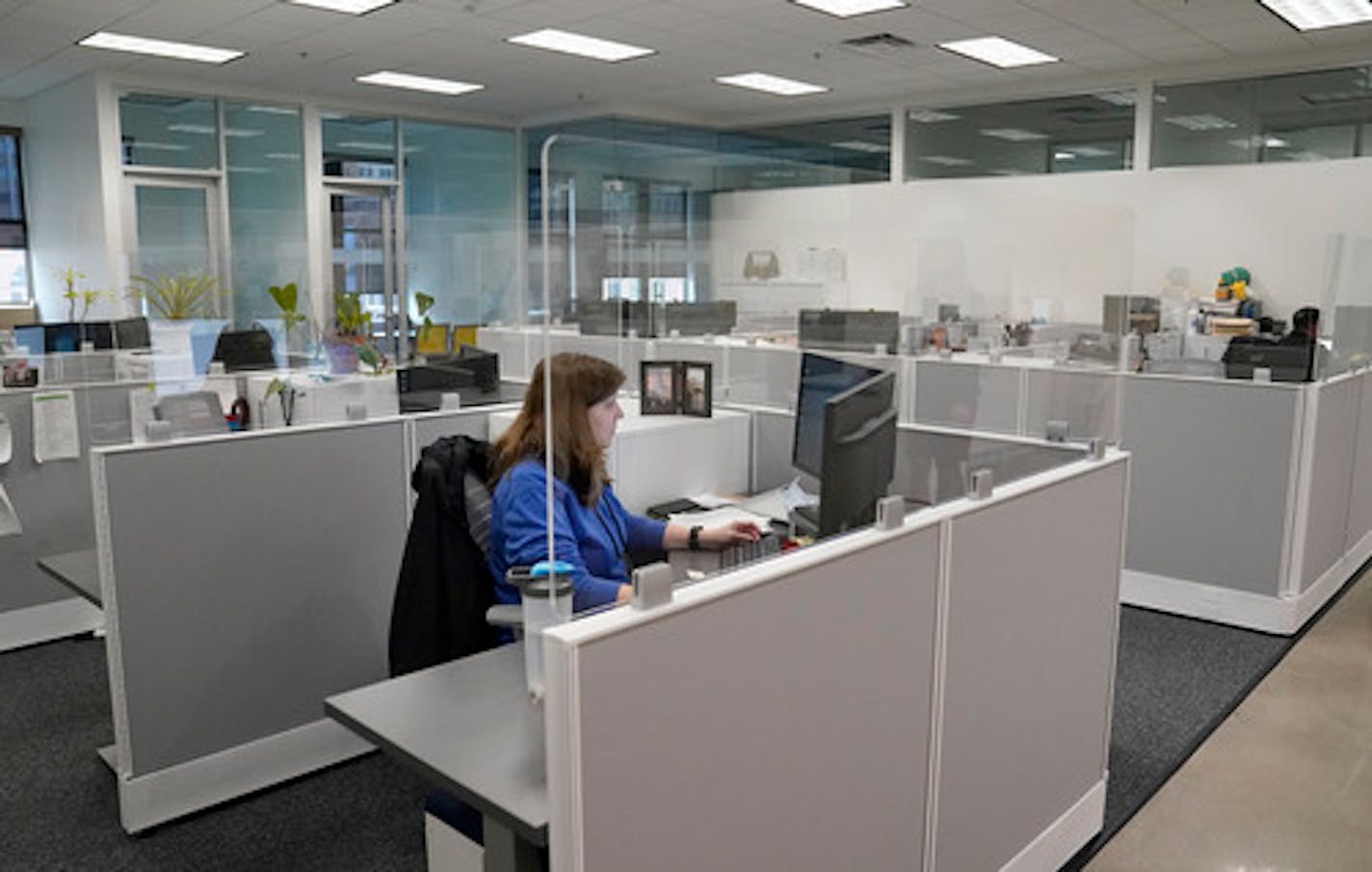 Protective plexiglass dividers between cubicles, where Karen Lohert, accounts payable and distribution specialist, was working at Delta Dental Minnesota's corporate offices in Minneapolis.