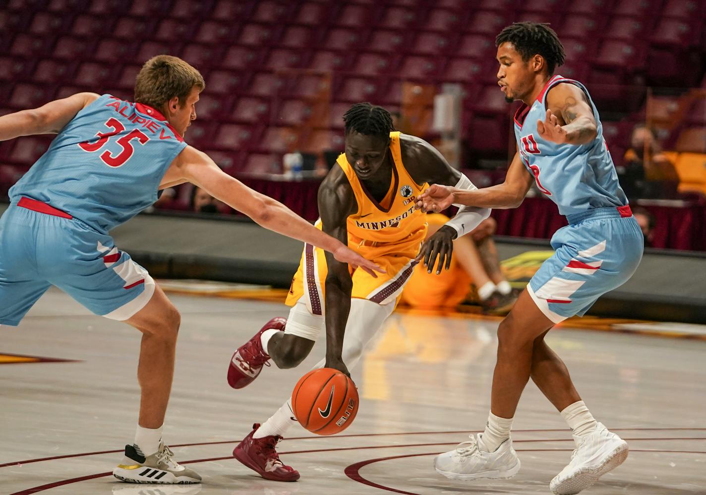 Gophers guard Both Gach dribbled through Loyola Marymount University forward Ivan Alipiev (35) and guard Quentin Jackson Jr. (10) in the first half of Minnesota's 88-73 victory at Williams Arena on Saturday. The two teams played again Monday night.