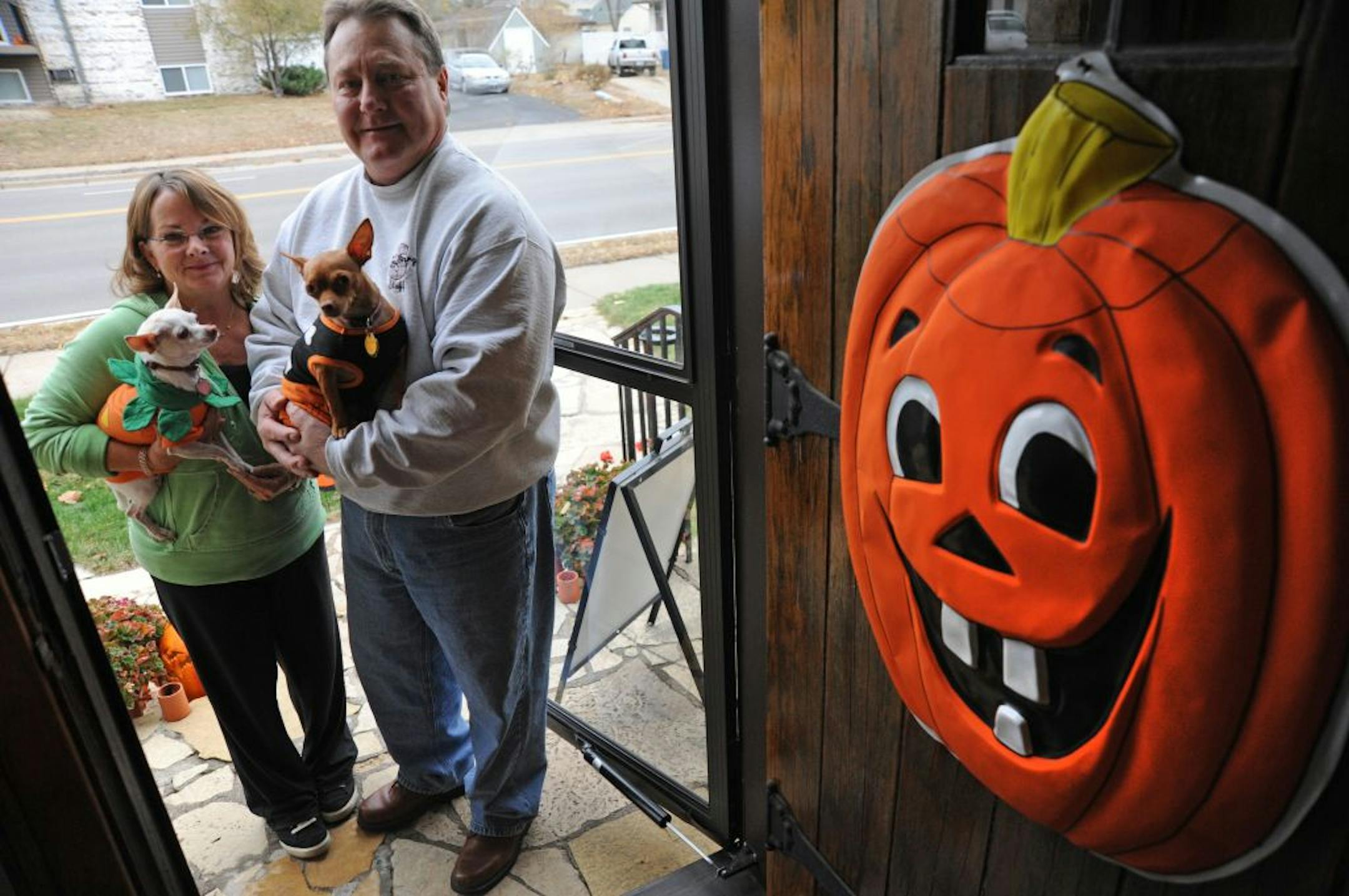 Ross and Jane Omdahl and their family have celebrated 50 years of Halloween in their home on the parade route of the Anoka Halloween Parade. They even have two Chihuaha dogs called princess which Jane was holding and Ross held Cami, both dogs are dressed Halloween in costumes .