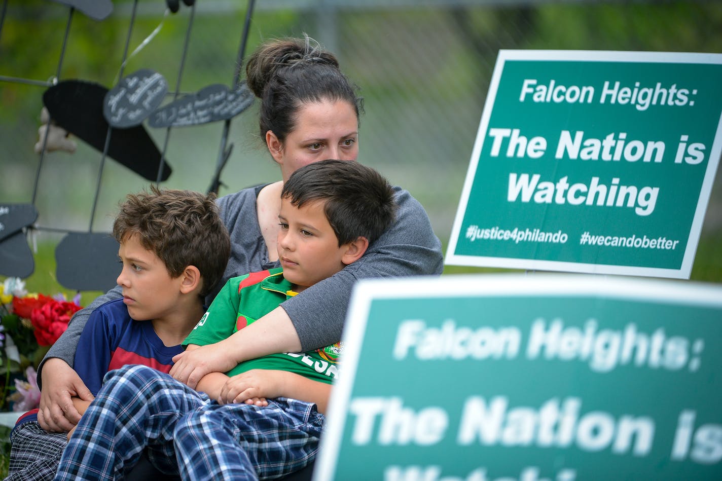 Kate Khaled, of St. Paul, and her two sons, Jibreel, 8, left, and Esa, 7, sat quietly at the memorial near the site where Philando Castile was shot and killed during a traffic stop by St. Anthony police officer Jeronimo Yanez last July. The two boys went to J.J. Hill Montessori and knew "Mr. Phil." ] AARON LAVINSKY &#xef; aaron.lavinsky@startribune.com Reactions at the site of where Philando Castile was shot in Falcon Heights photographed Friday, June 16, 2017.