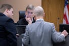 Judge R. Michael Waterman, center, listens to defense attorneys Corey Chirafisi, right, and County District Attorney Karl Anderson, left, during the N