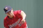 Minnesota Twins' starting pitcher Tommy Milone delivers against the New York Yankees in the first inning during an exhibition spring training baseball