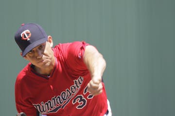 Minnesota Twins' starting pitcher Tommy Milone delivers against the New York Yankees in the first inning during an exhibition spring training baseball