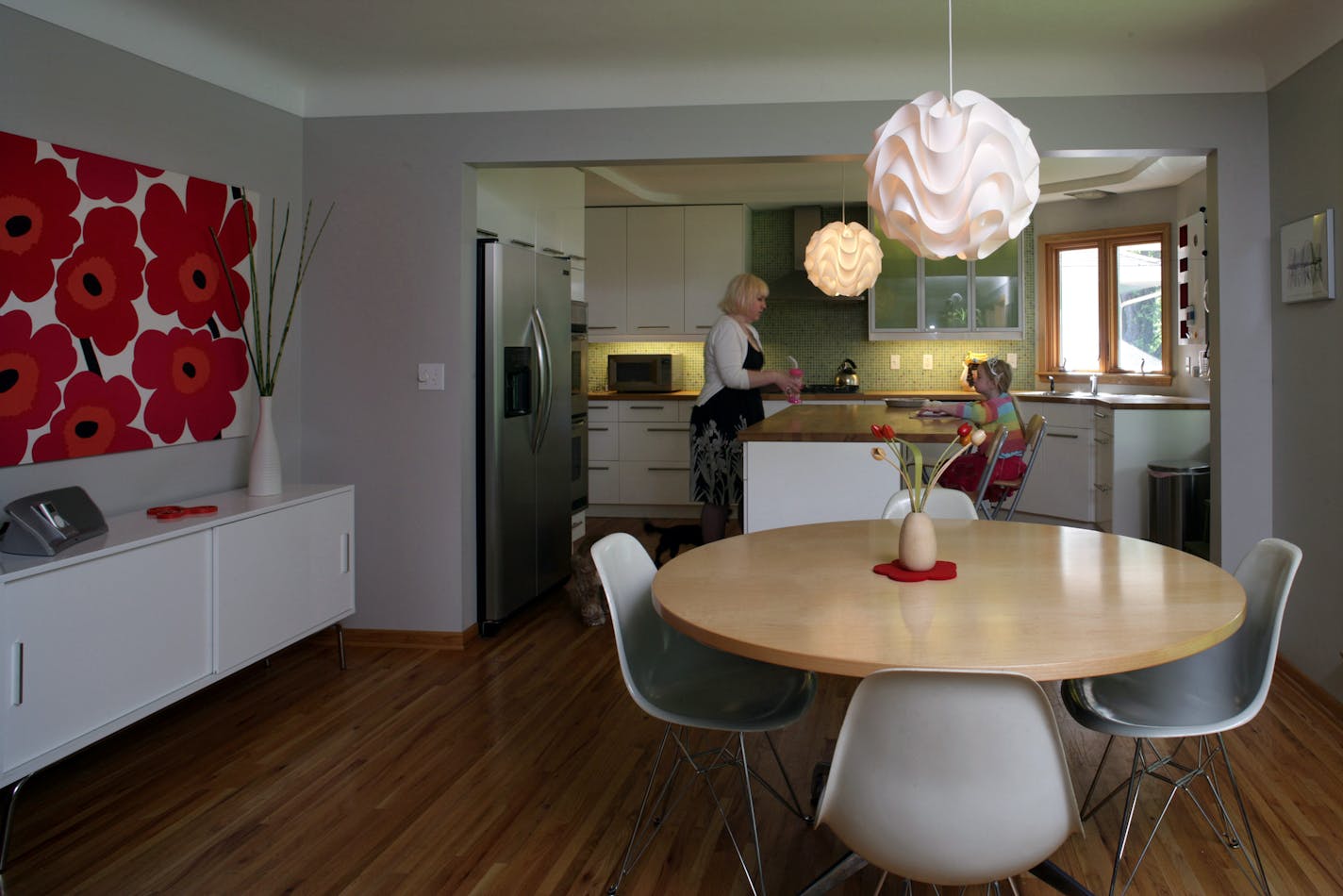 Architect and homeowner Judy Grundstrom, pictured with daughter, Tuesday, updated her 1950s rambler by opening up the kitchen, then doing a complete cosmetic makeover.